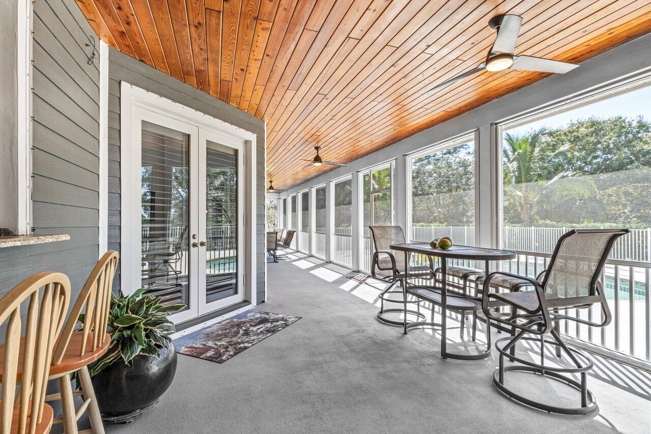 1802 Southwest Trailside Path Stuart, FL 34997 - Photo 30 of 57 a view of a patio with a table chairs and balcony