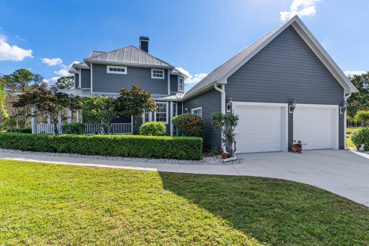 1802 Southwest Trailside Path Stuart, FL 34997 - Photo 35 of 57 a front view of house with yard and green space