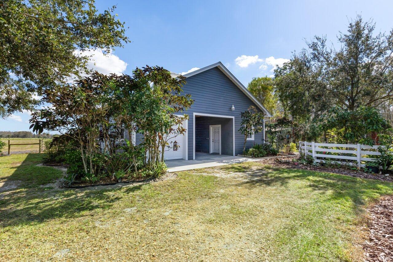 1802 Southwest Trailside Path Stuart, FL 34997 - Photo 39 of 57 a view of a house with backyard and trees