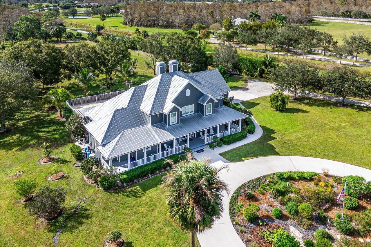 1802 Southwest Trailside Path Stuart, FL 34997 - Photo 48 of 57 an aerial view of a house with a garden and lake view