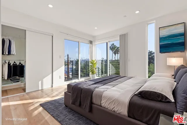 a bedroom with a large bed and a window