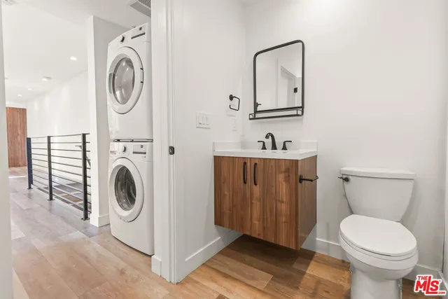 a bathroom with a sink mirror and toilet