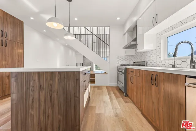 a kitchen with cabinets a sink and appliances