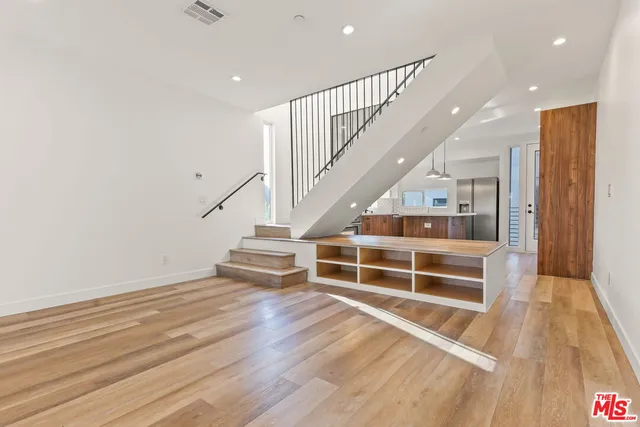 a view of entryway with wooden floor and stairs