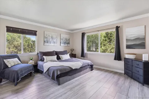 a bedroom with a large bed and a couch