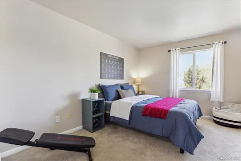 a bed room with a bed and a window