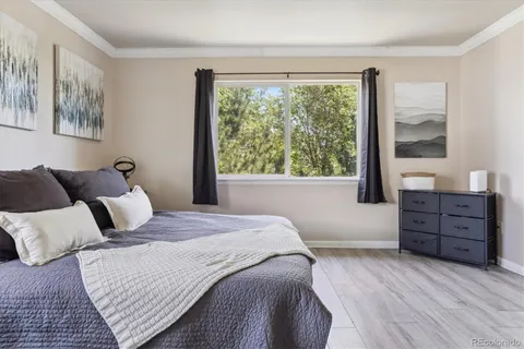 a bedroom with a bed and wooden floor