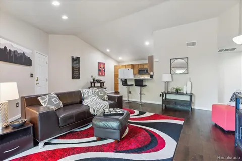 a living room with furniture and wooden floor