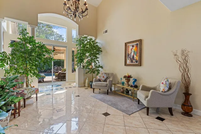 a view of a dining room with furniture a chandelier and wooden floor