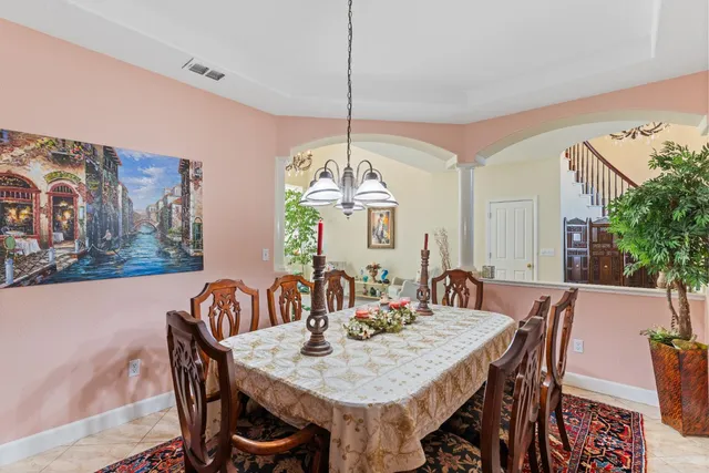 a kitchen with sink a stove and chairs