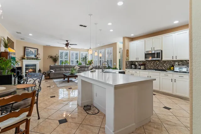 a bathroom with a tub a sink and a large mirror