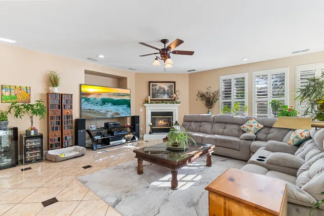 a bedroom with a bed chandelier and a window