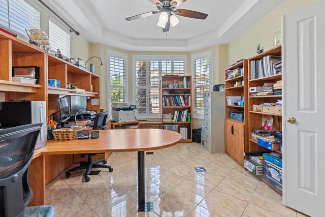 a bedroom with a bed and a chandelier fan