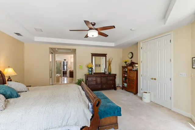 a white toilet sitting next to a sink and a shower curtain