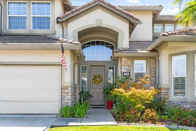 a front view of a house with garden