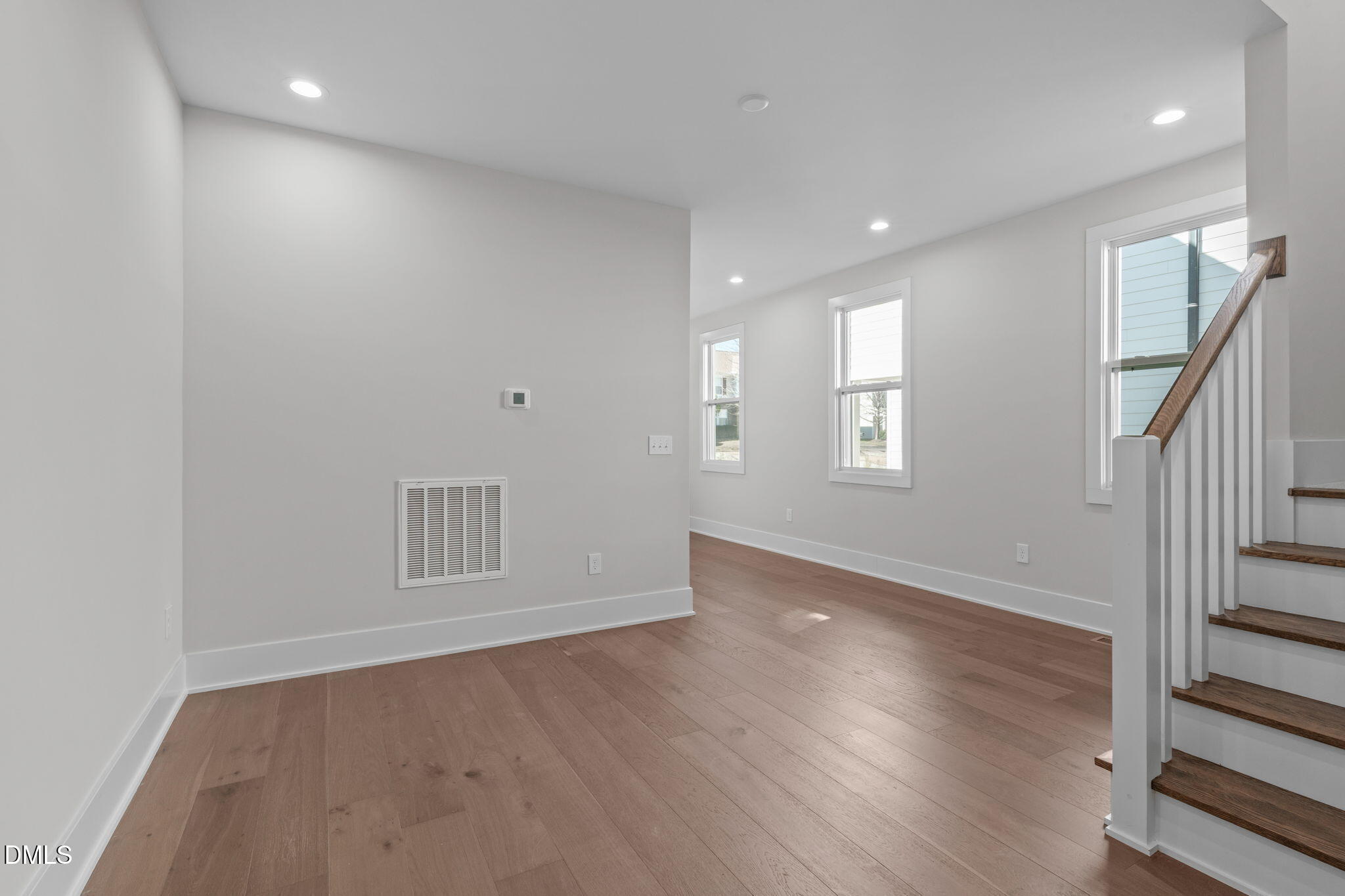 639 Conover Road, Unit A Durham, NC 27703 - Photo 13 of 49 an empty room with wooden floor and windows