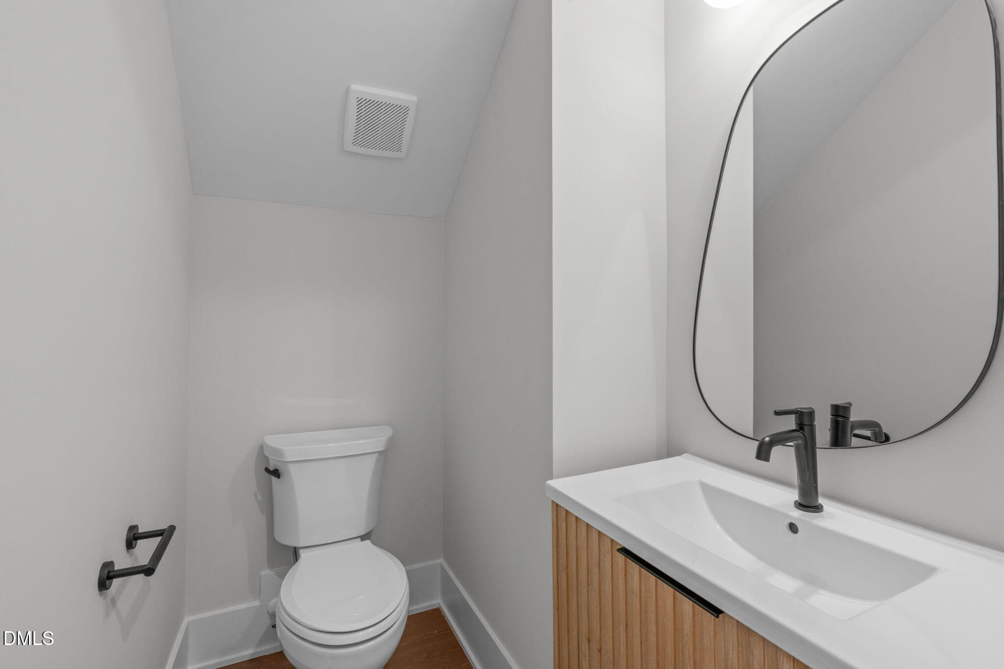 639 Conover Road, Unit A Durham, NC 27703 - Photo 14 of 49 a bathroom with a sink a toilet and mirror