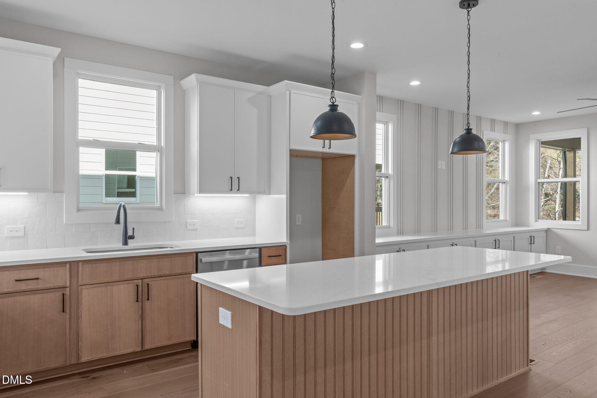 639 Conover Road, Unit A Durham, NC 27703 - Photo 16 of 49 a kitchen with a sink a center island a counter space and a window