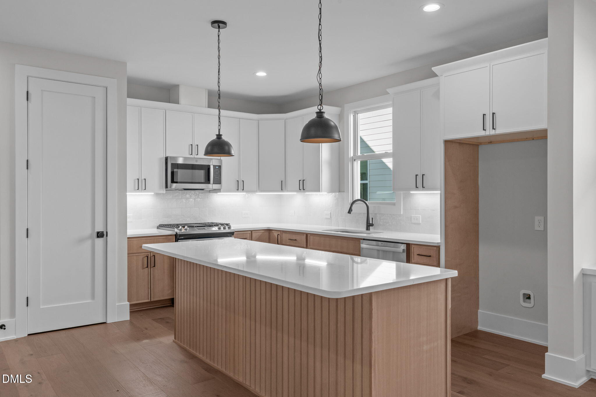 639 Conover Road, Unit A Durham, NC 27703 - Photo 17 of 49 a kitchen with stainless steel appliances granite countertop a sink a stove a refrigerator and island with wooden floor