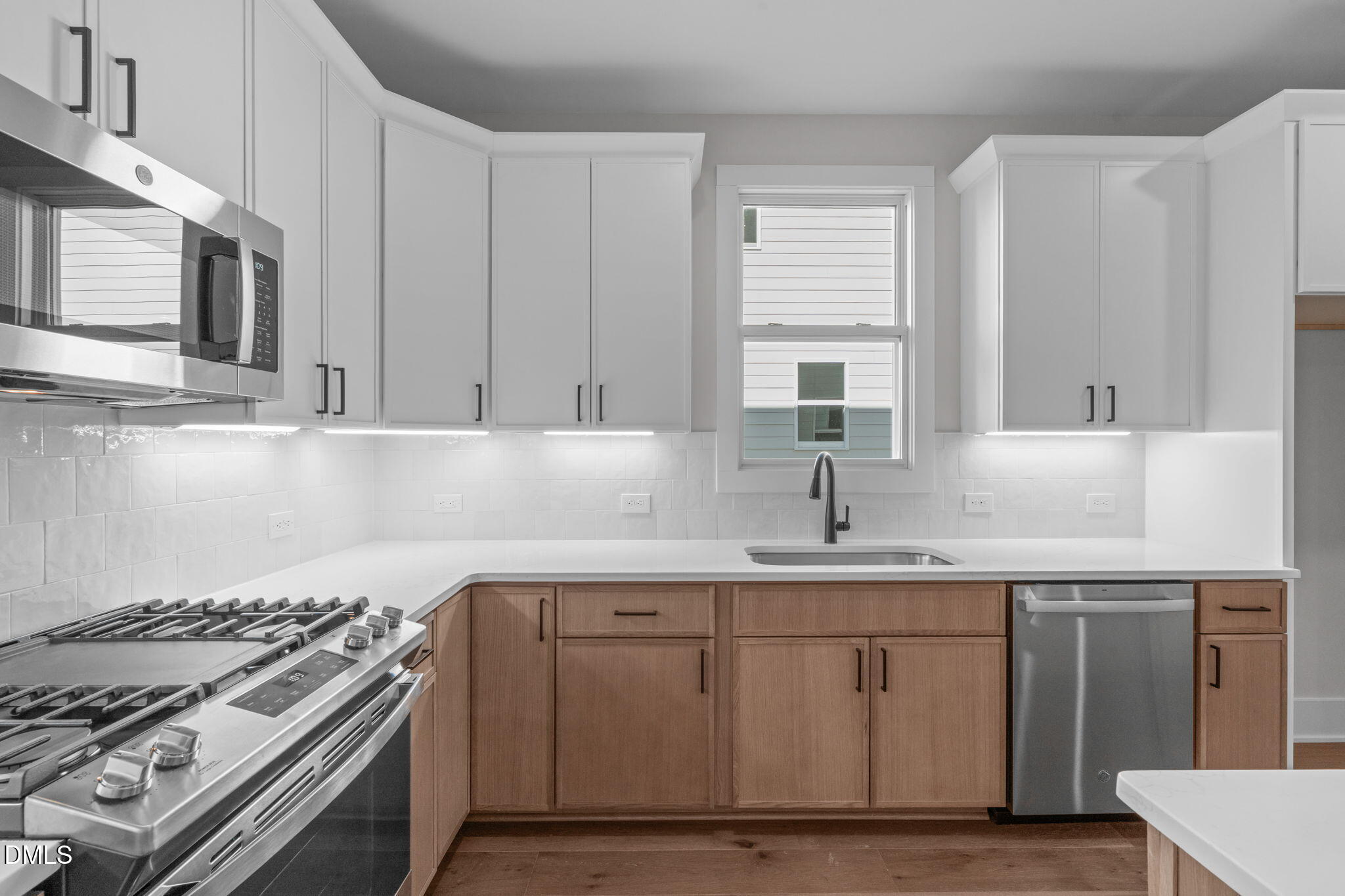 639 Conover Road, Unit A Durham, NC 27703 - Photo 20 of 49 a kitchen with stainless steel appliances a sink stove and cabinets
