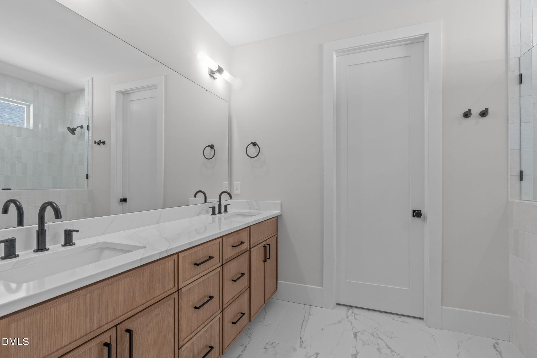 639 Conover Road, Unit A Durham, NC 27703 - Photo 29 of 49 a bathroom with a double vanity sink and a mirror