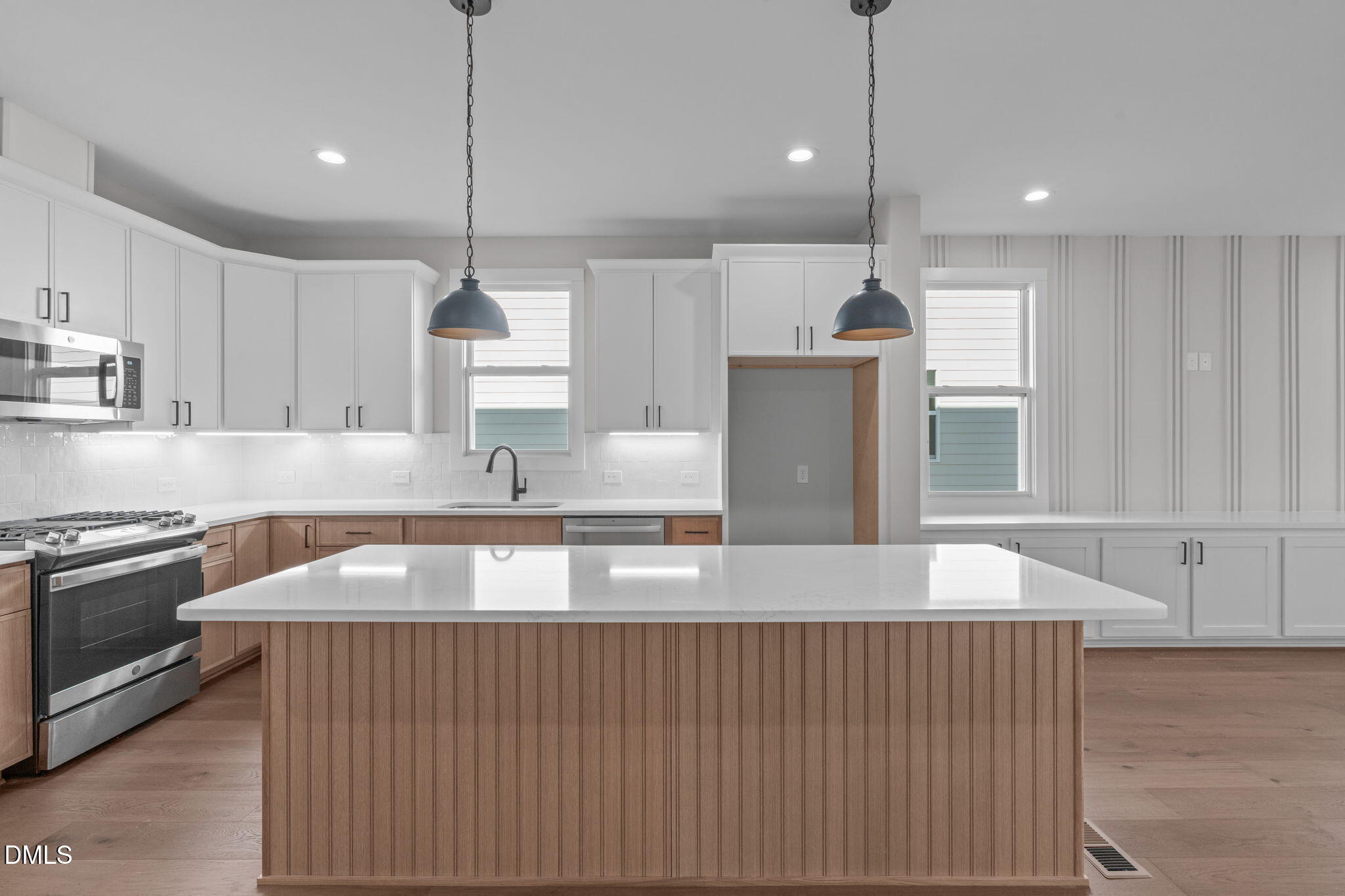 639 Conover Road, Unit A Durham, NC 27703 - Photo 2 of 49 a kitchen with kitchen island granite countertop a sink a counter space appliances and cabinets
