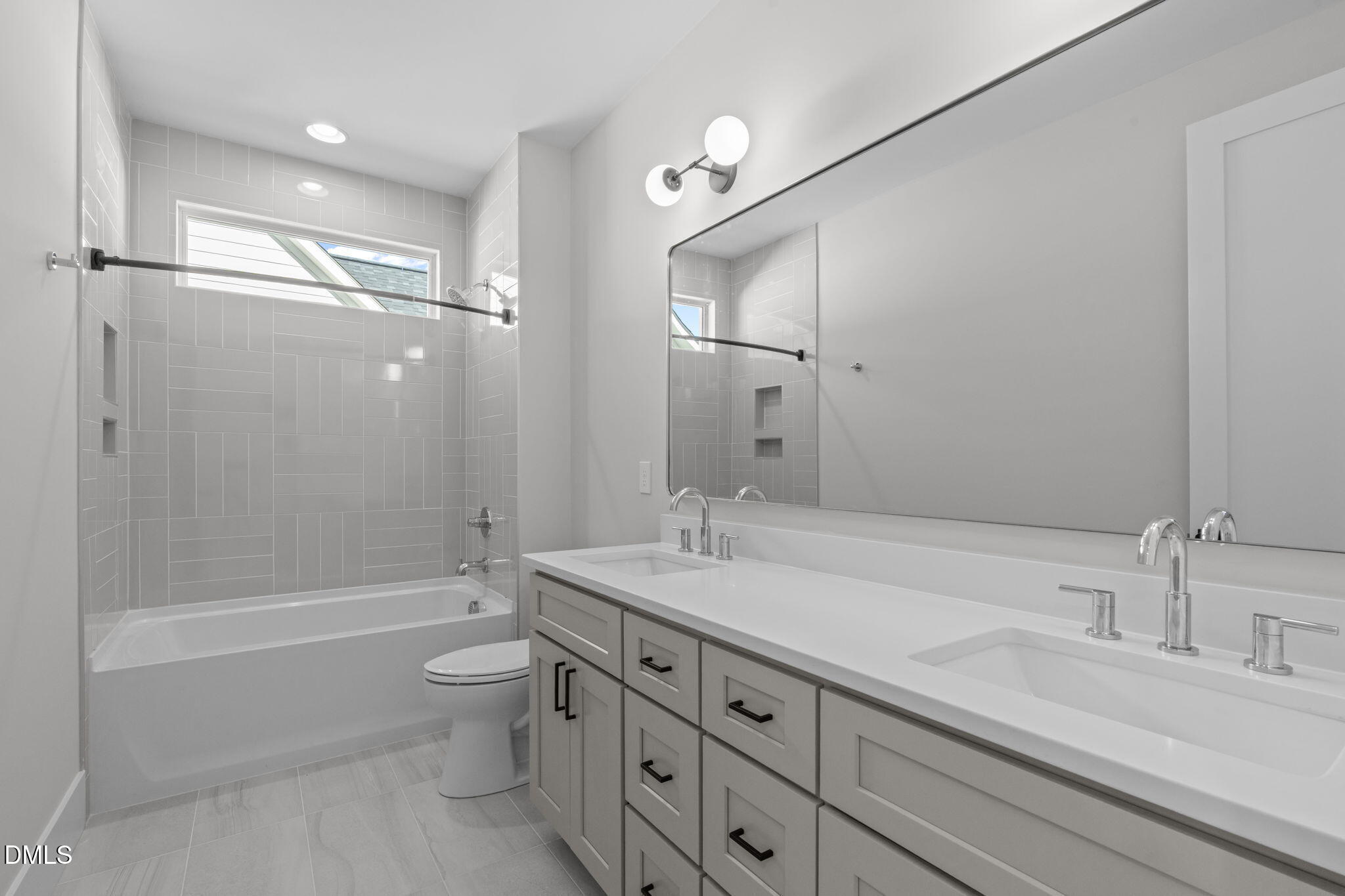 639 Conover Road, Unit A Durham, NC 27703 - Photo 36 of 49 a bathroom with a granite countertop sink a toilet a mirror and shower