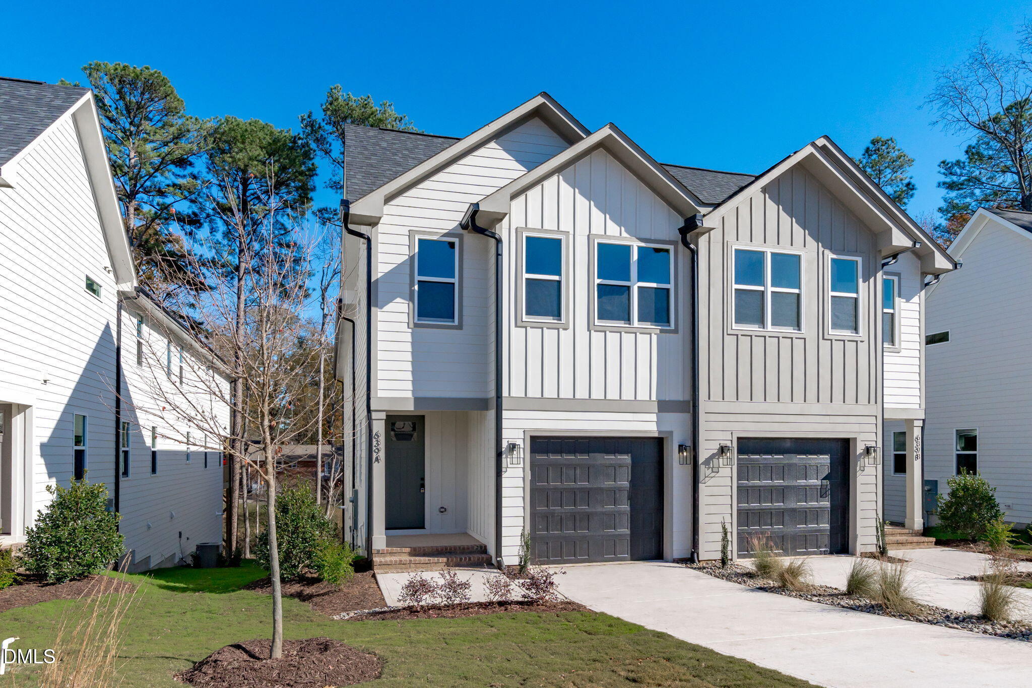 639 Conover Road, Unit A Durham, NC 27703 - Photo 6 of 49 a front view of a house with a yard and garage