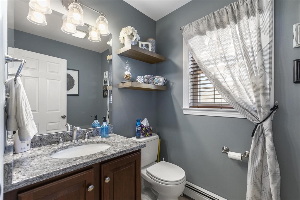 16 Windsor Street Everett, MA 02149 - Photo 13 of 40 a bathroom with a granite countertop sink vanity mirror and toilet