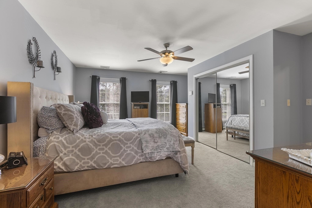 16 Windsor Street Everett, MA 02149 - Photo 15 of 40 a bedroom with a large bed and a chandelier