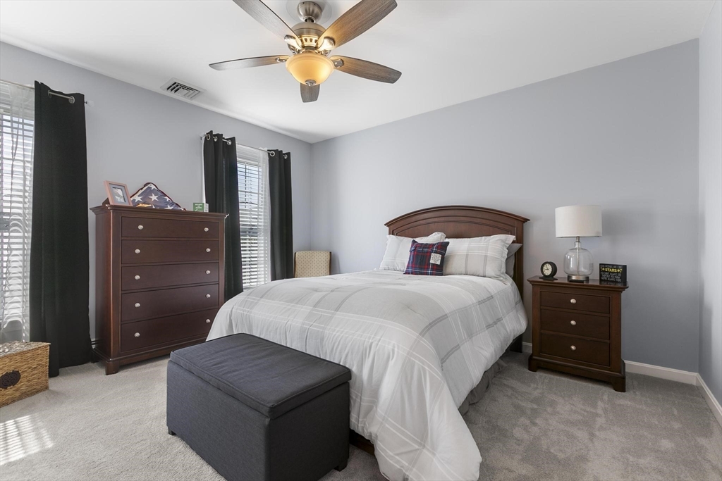 16 Windsor Street Everett, MA 02149 - Photo 19 of 40 a bedroom with a bed and a chandelier