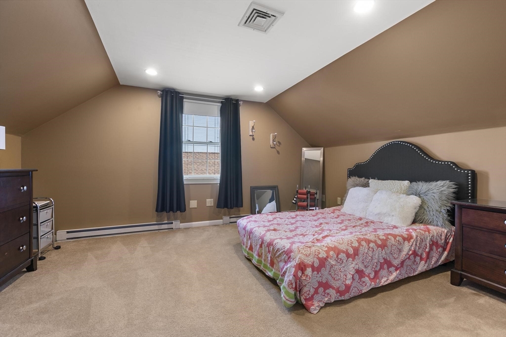 16 Windsor Street Everett, MA 02149 - Photo 22 of 40 a bedroom with a bed and a night stand