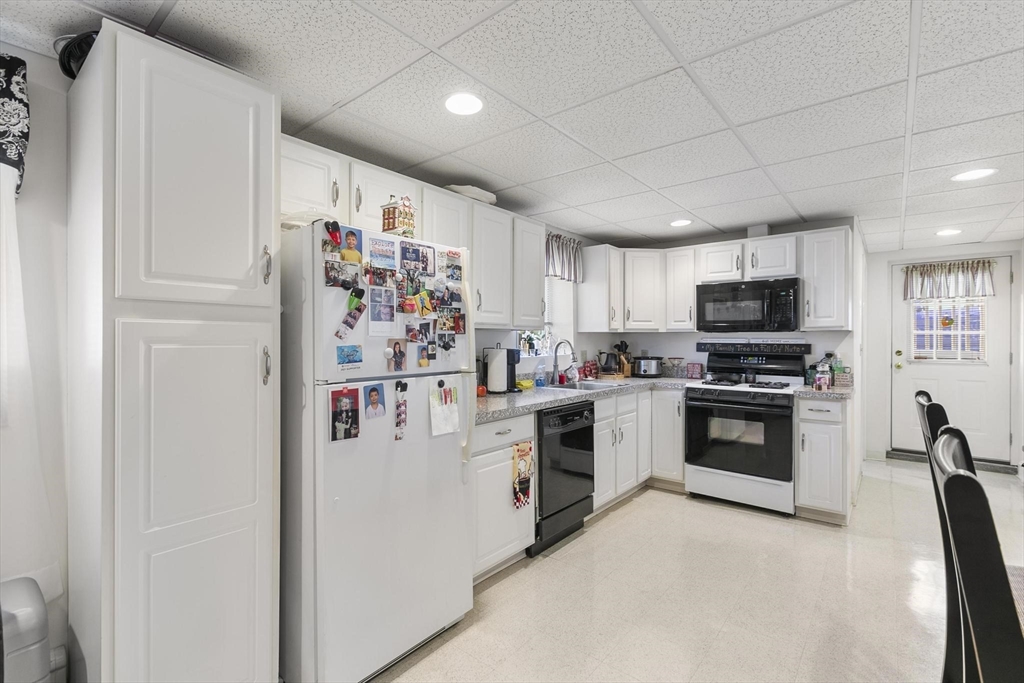 16 Windsor Street Everett, MA 02149 - Photo 28 of 40 a kitchen with granite countertop stainless steel appliances and refrigerator