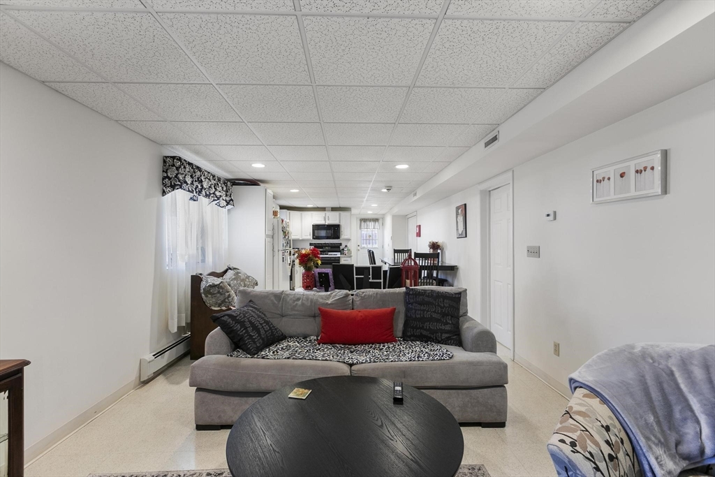 16 Windsor Street Everett, MA 02149 - Photo 29 of 40 a living room with furniture and a flat screen tv