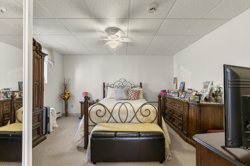 16 Windsor Street Everett, MA 02149 - Photo 30 of 40 a bedroom with a bed and a chandelier