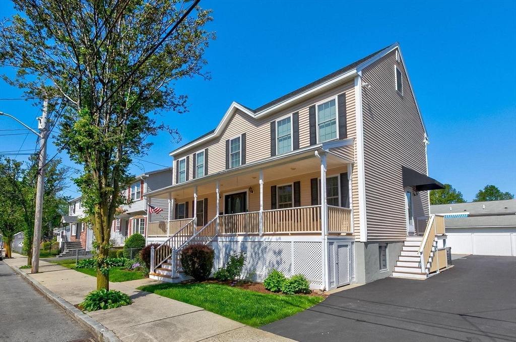 16 Windsor Street Everett, MA 02149 - Photo 40 of 40 a front view of a house with a garden and trees