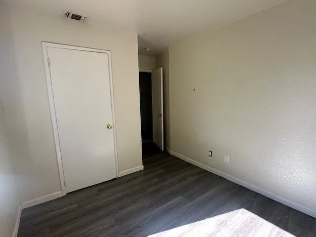 an empty room with wooden floor