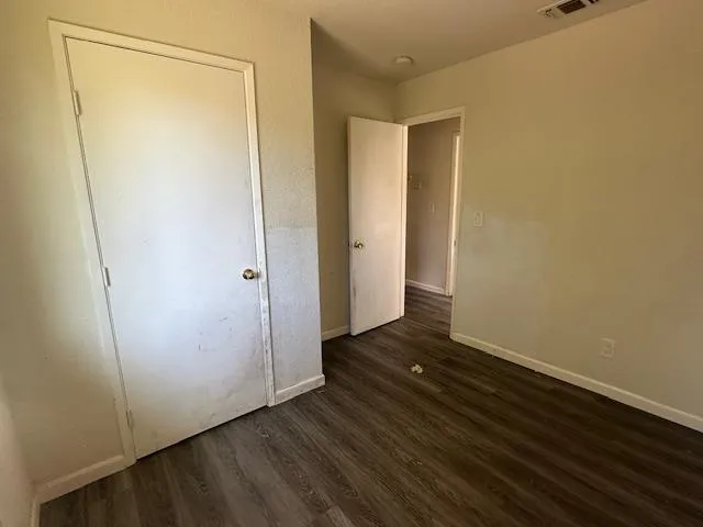 a view of a room with wooden floor