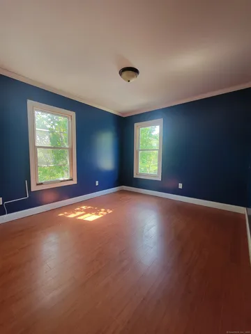 an empty room with windows and closet