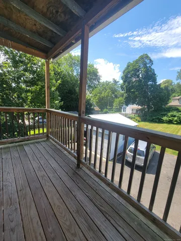 a view of balcony with wooden floor