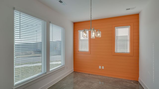 a room with pool table and windows