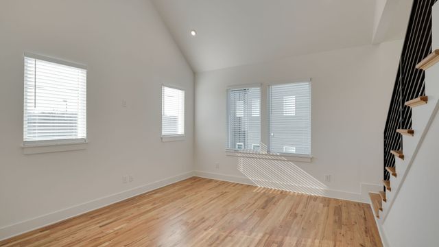 a view of an empty room and wooden floor