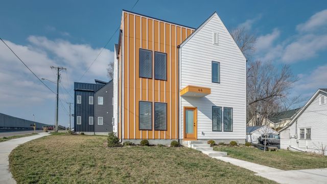 a view of house with a yard