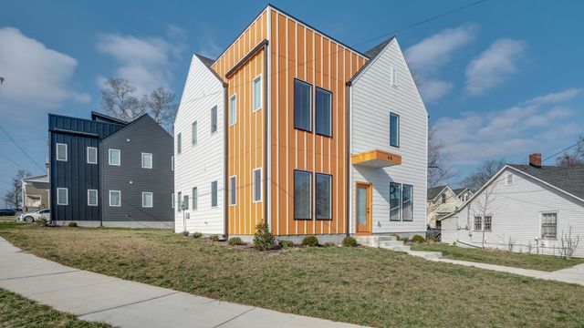 a view of a kitchen with refrigerator and wooden floor