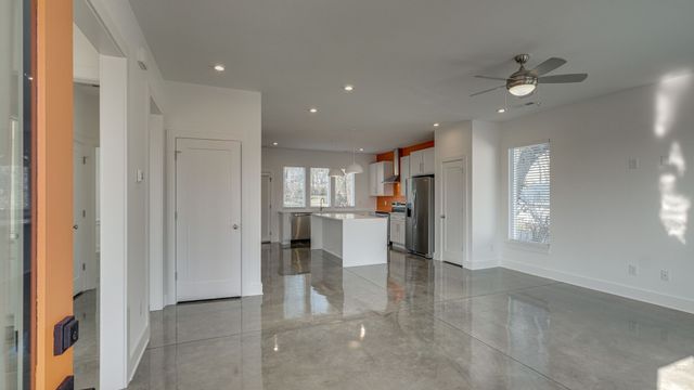 a view of a kitchen with refrigerator and windows
