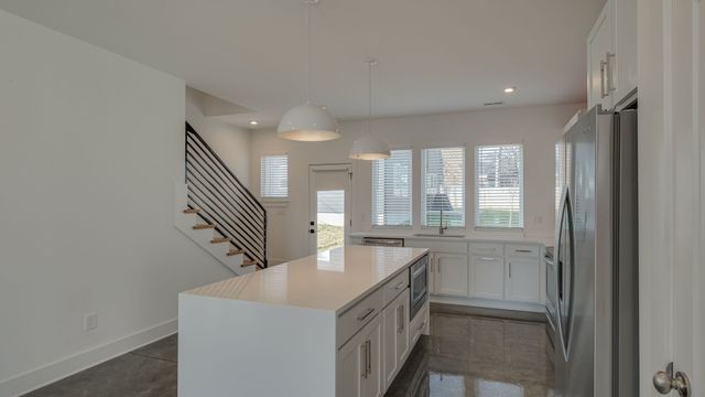 a kitchen with stainless steel appliances a refrigerator and a sink