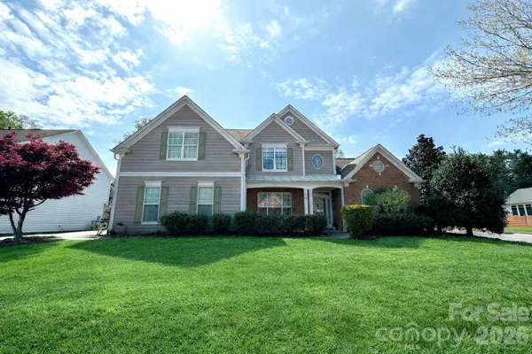 a front view of house with yard and green space