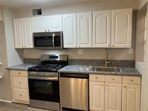 1148 Briarcliff Road Northeast, Unit 1 Atlanta, GA 30306 - Photo 6 of 33 a kitchen with granite countertop white cabinets and stainless steel appliances