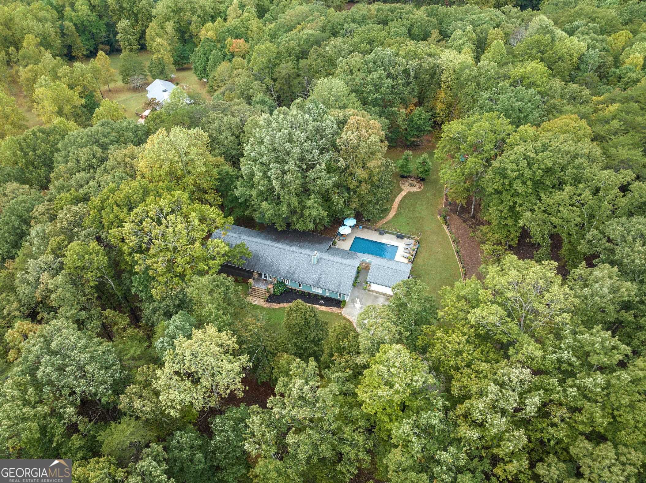 an aerial view of a house with a yard