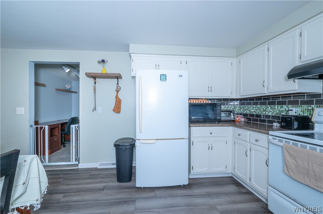6463 Ward Road Sanborn, NY 14132 - Photo 18 of 49 Crisp cabinetry contrasts with warm flooring to define this functional kitchen space.